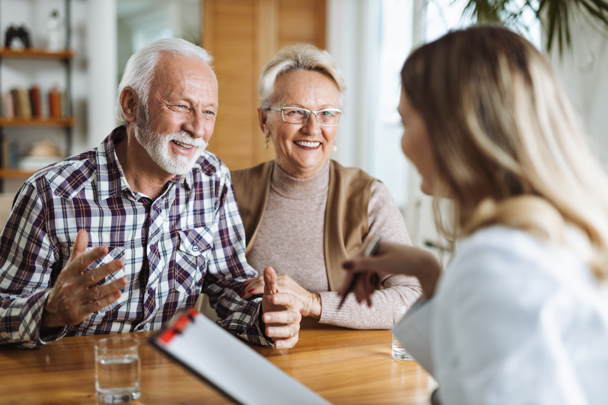 Senior couple consulting with a healthcare professional for senior care options.