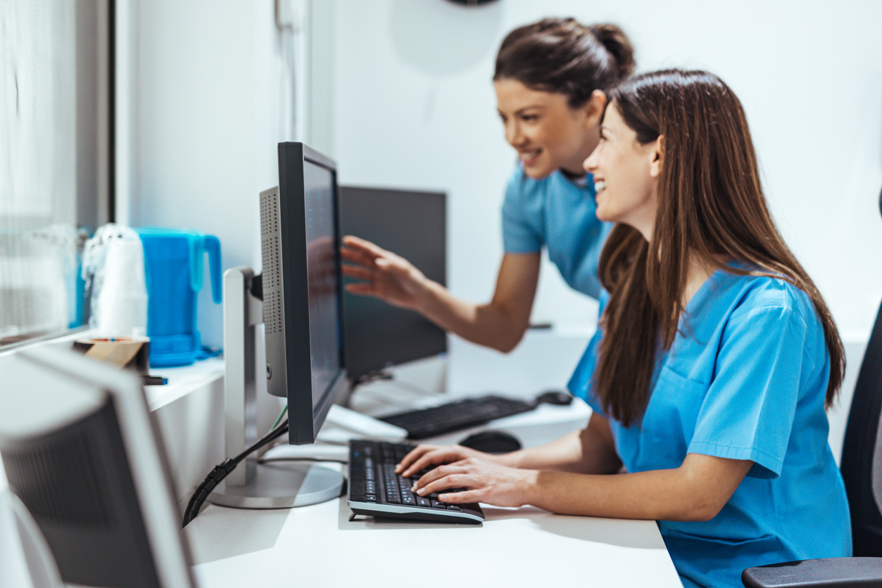 RNs reviewing senior care options and assessments on computer.